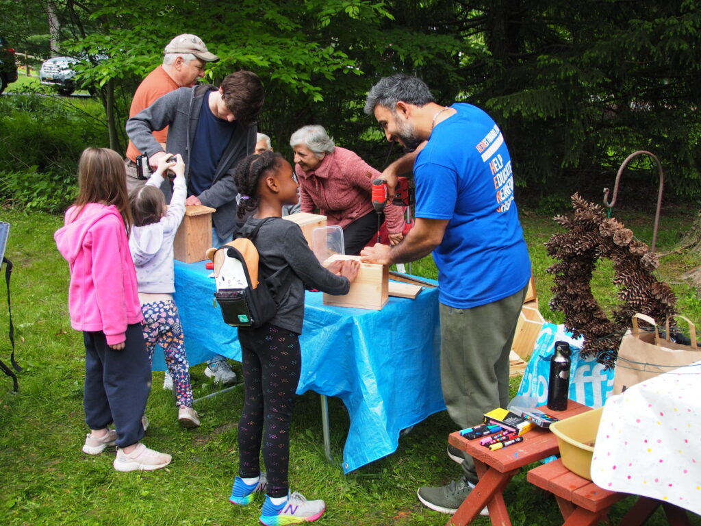 A group of people standing around a table.